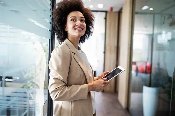 Female in the office holding her phone