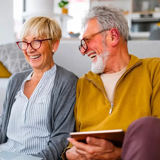 Happy Retirees sitting on couch