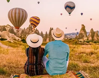 Couple watching hot air balloons