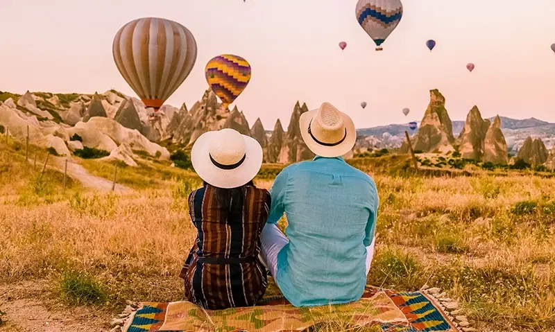 Couple watching hot air balloons