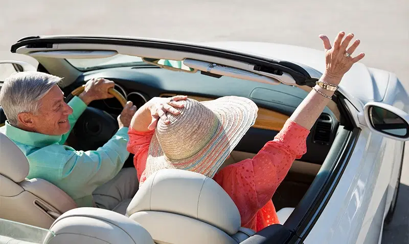 Retired couple in a convertable