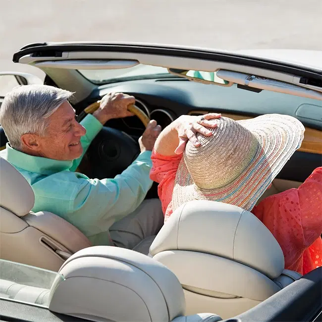 Retired couple in a convertable