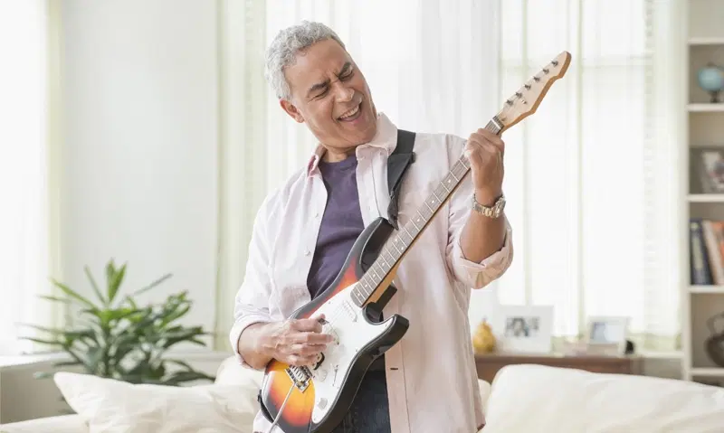 Retiree playing the guitar