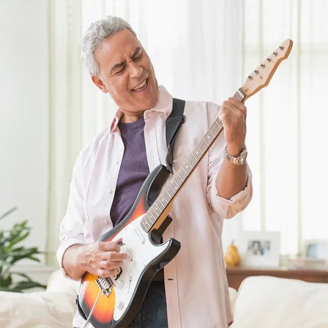 Retiree playing the guitar