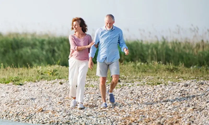 Retired walking on the beach